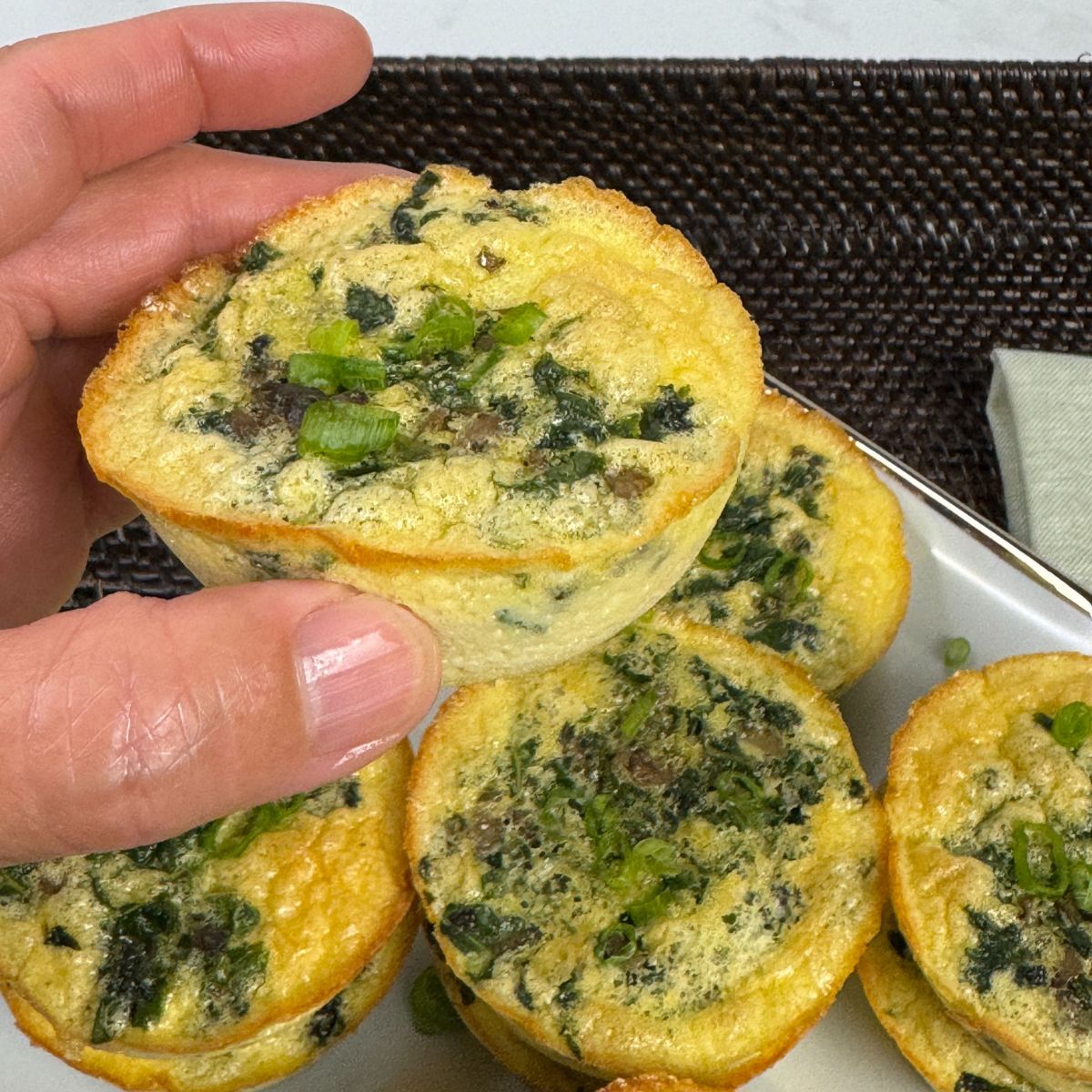 Kale and mushroom egg bite in hand