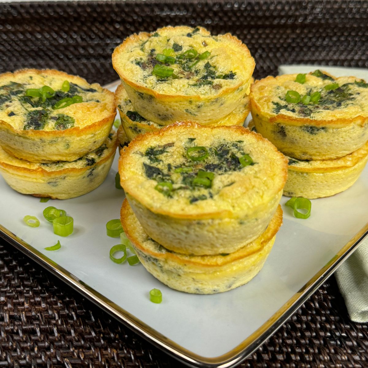 kale and mushroom egg bites stacked on a plate