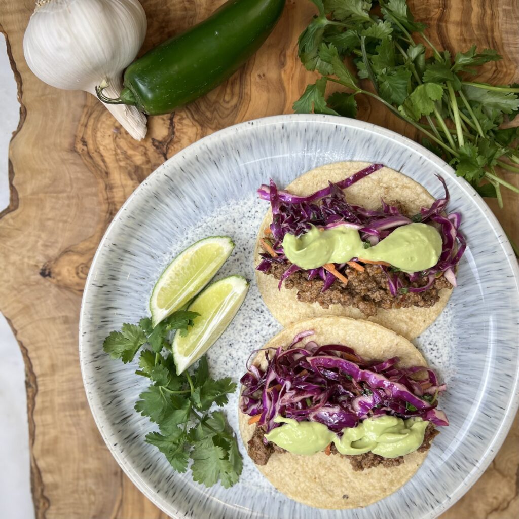 Bison tacos with spicy avocado cream.