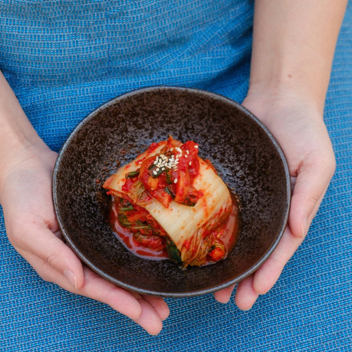 Bowl of kimchi in hands